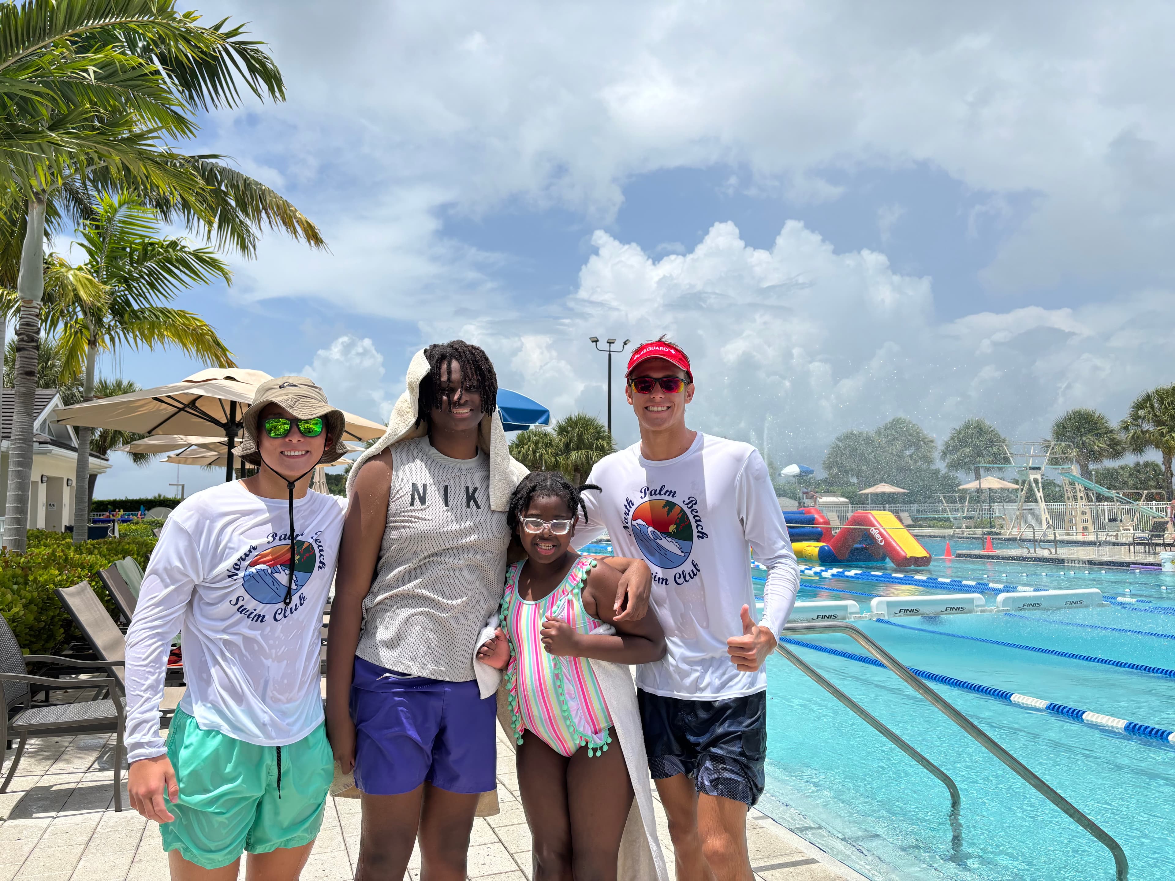 Swim for Life coaches and a young swimmer at the pool